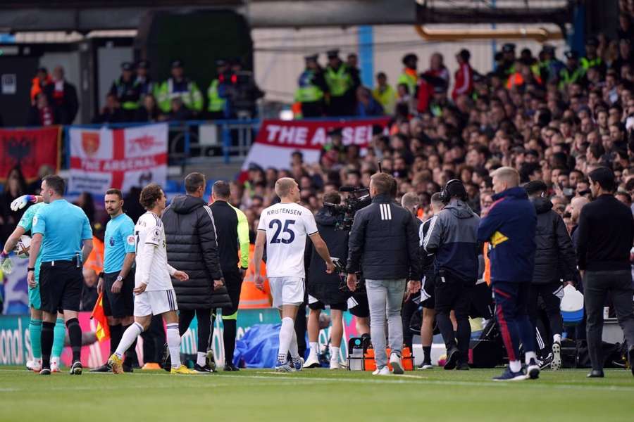 Players and staff from Leeds and Arsenal walk down the tunnel.