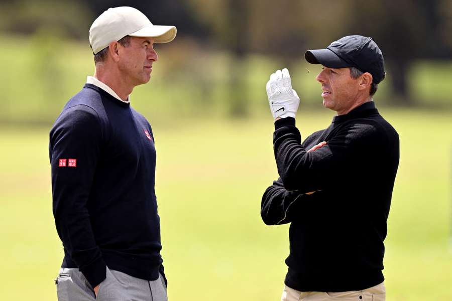 Adam Scott chats with Rory McIlroy at Royal Melbourne Golf Club on Tuesday.