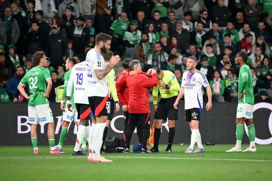 Medics treat assistant referee Mehdi Rahmouni during Saint-Etienne's match with Lyon