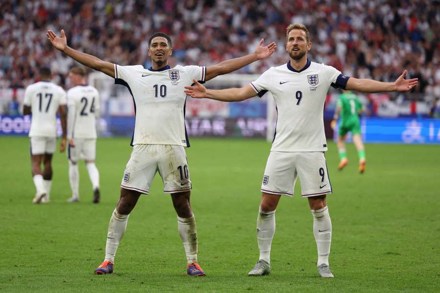 Jude Bellingham celebrates with Harry Kane after scoring England's opening goal against Slovakia in the Round of 16 at Euro 2024.