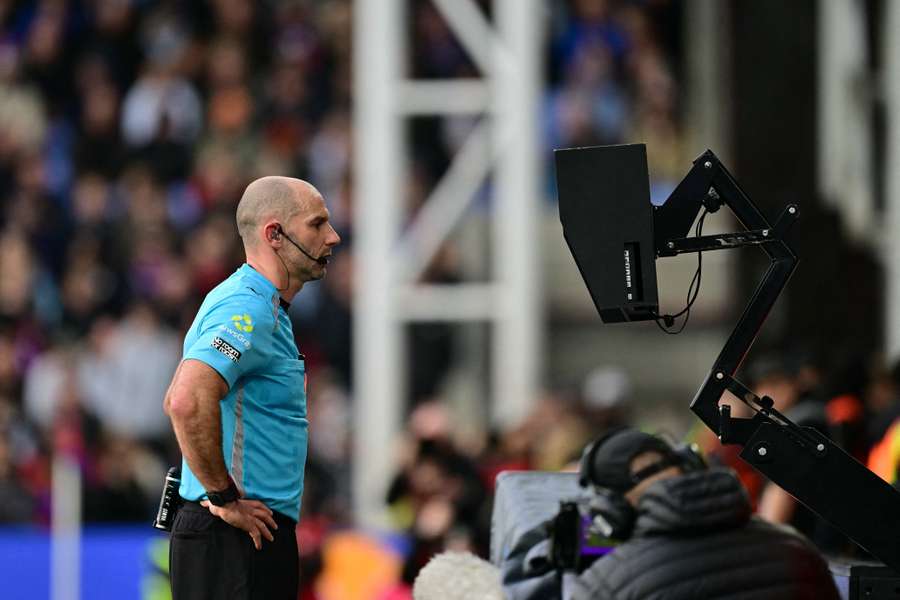 Referee Tim Robinson checks the on-field VAR screen Referee Tim Robinson checks the on-field VAR screen