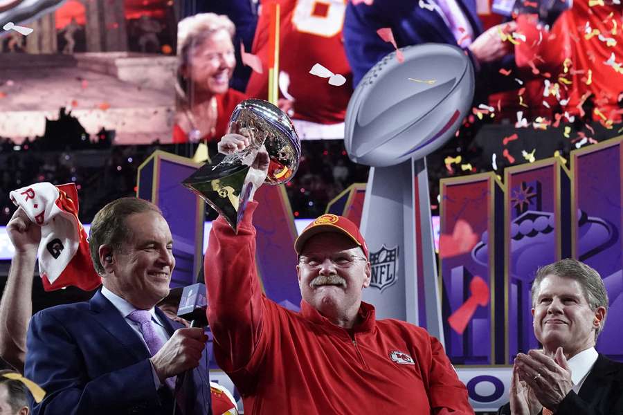 Kansas City Chiefs head coach Andy Reid holds the trophy next to owner, chairman and CEO Clark Hunt (right) after winning the Super Bowl