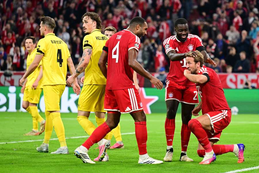 Bayern Munich's Harry Kane celebrates scoring their second goal with Jonathan Tah and Dayot Upamecano