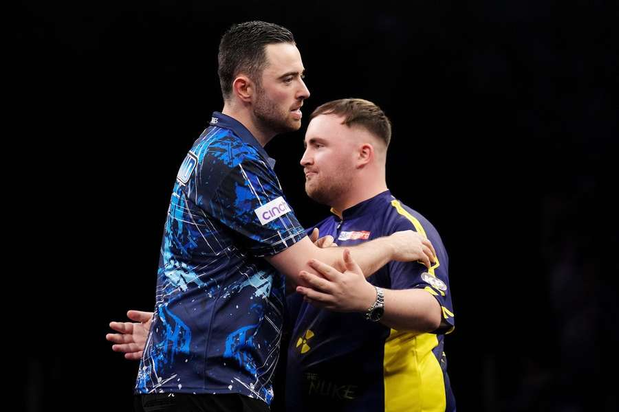 Luke Humphries (left) wins the final and is embraced by Luke Littler during the BetMGM Premier League Play-Offs at The O2