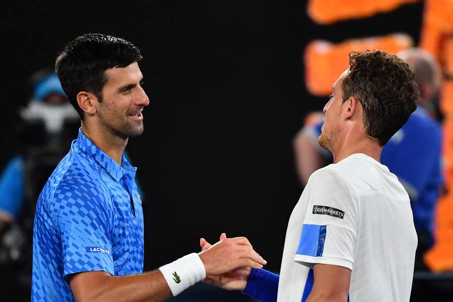 Djokovic and Carballes Baena shake hands after their match