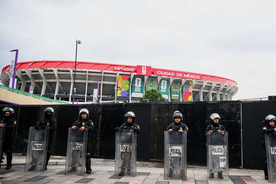 Police officers stand in front of the Azteca Stadium, where the opening game will be played Police officers stand in front of the Azteca Stadium, where the opening game will be played