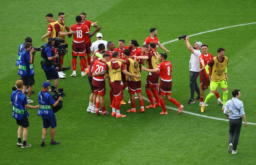 Switzerland's players celebrate after beating Italy