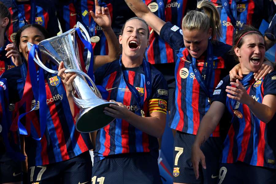 Barcelona midfielder Alexia Putellas and her teammates celebrate with the trophy after winning the women's Champions League