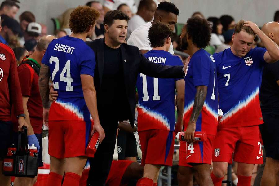 Pochettino speaks to his players during the match