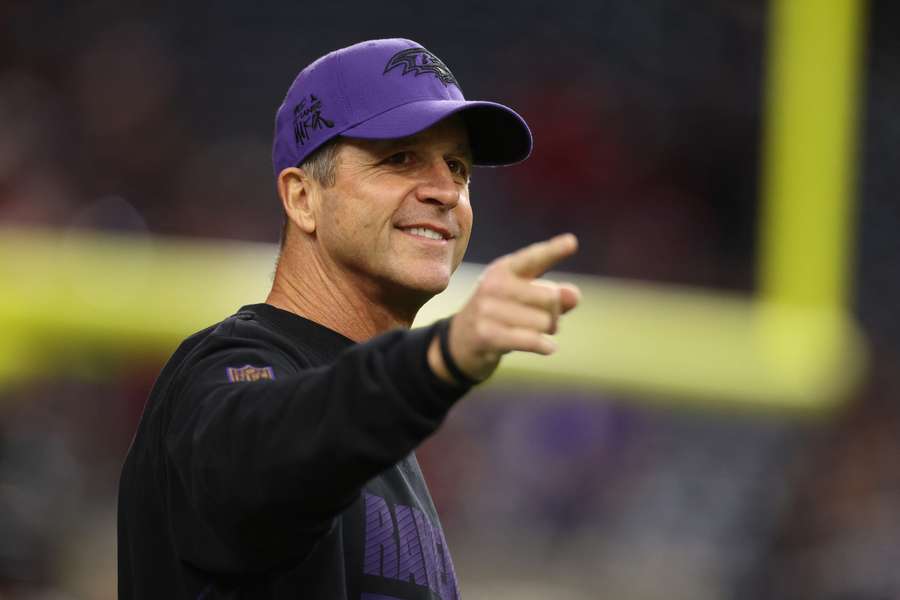 Baltimore Ravens head coach John Harbaugh smiling ahead of a game against the Houston Texans