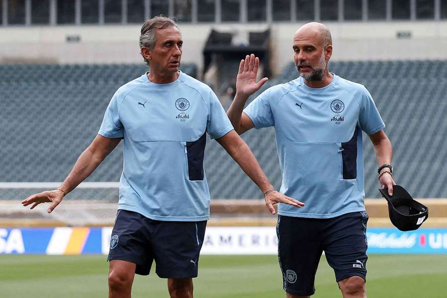 Pep Guardiola (right) walks on the pitch at the Lincoln Financial Field stadium in Philadelphia