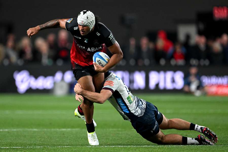 Canterbury's Leicester Fainga'anuku attempts to evade a tackle.