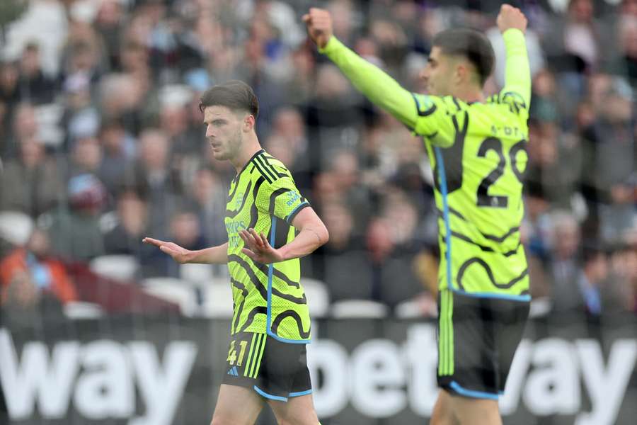 Arsenal's English midfielder #41 Declan Rice (L) reacts after scoring their sixth goal