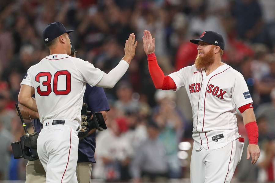 Red Sox designated hitter Justin Turner (2) and left fielder Rob Refsnyder (30) celebrate after defeating the Yankees at Fenway Park