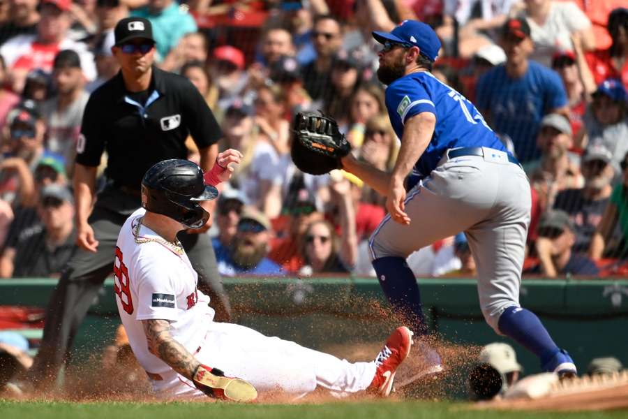 Red Sox fielder Alex Verdugo slides into first base