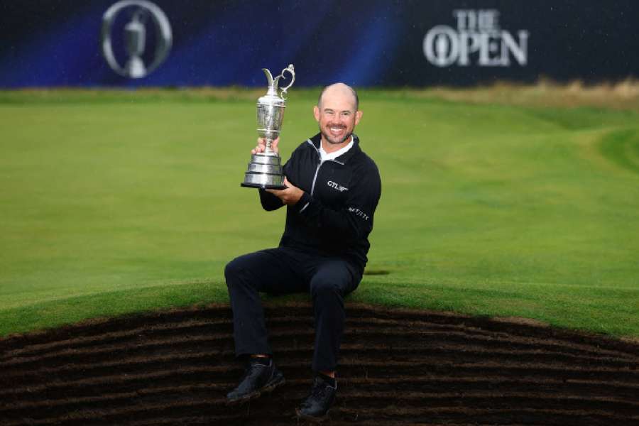 Brian Harman poses with the Claret Jug as he celebrates winning the 151st Open Championship