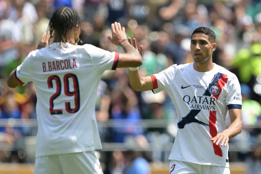 Achraf Hakimi celebrates with Bradley Barcola after scoring PSG's second goal