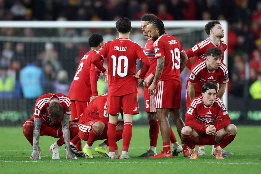 Wales' Harry Wilson looks dejected with teammates after the match
