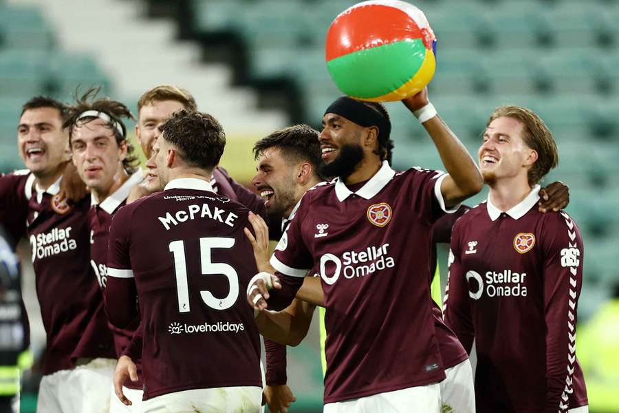 Severin Sabri Guendouz celebrates with an inflatable ball and teammates after the match