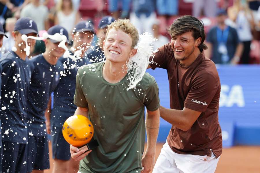 Bastad winner Luciano Darderi sprays champagne on Jesper de Jong after the latter reached his first ATP final