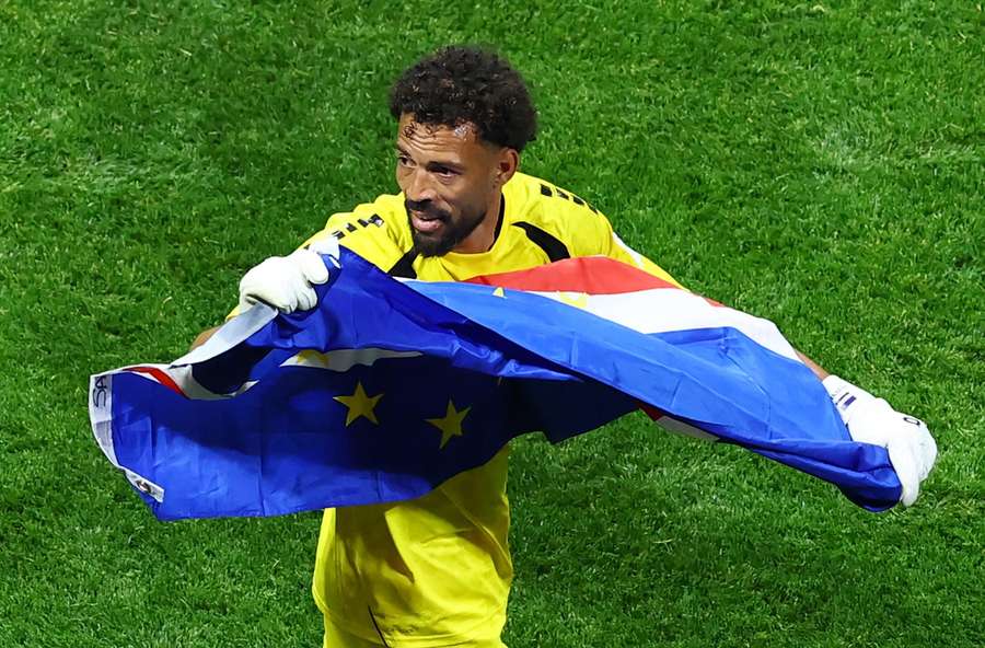 Cape Verde's Vozinha celebrates with their national flag after the match Cape Verde's Vozinha celebrates with their national flag after the match