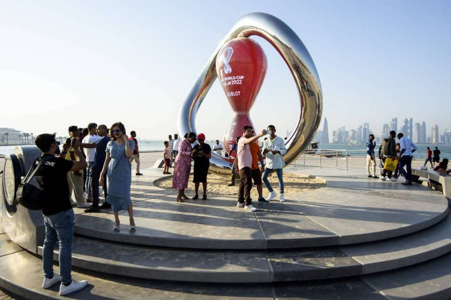 People take photos in front of the FIFA World Cup 2022 Qatar countdown clock in Doha.