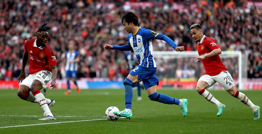 Aaron Wan-Bissaka and Antony vie with Brighton's Japanese midfielder Kaoru Mitoma Aaron Wan-Bissaka and Antony vie with Brighton's Japanese midfielder Kaoru Mitoma