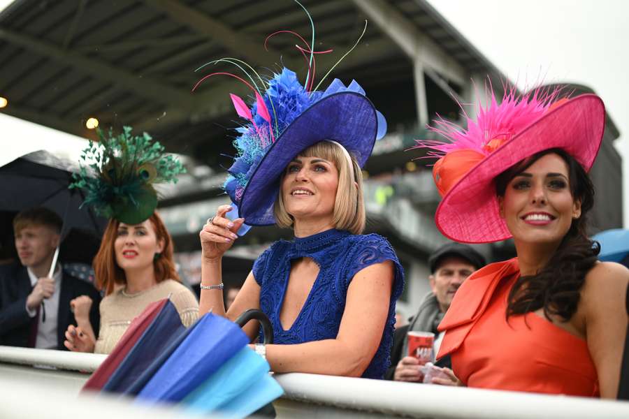 Racegoers watch the fifth race on the second day of the Grand National Festival