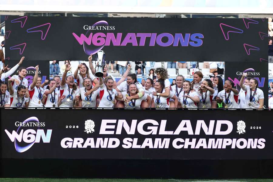 Meg Jones lifts the trophy as she celebrate winning the Women's Six Nations Championship and the Grand Slam with England teammates