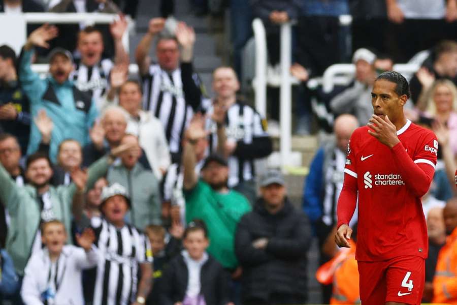 Van Dijk walks off the pitch after he is shown a red card