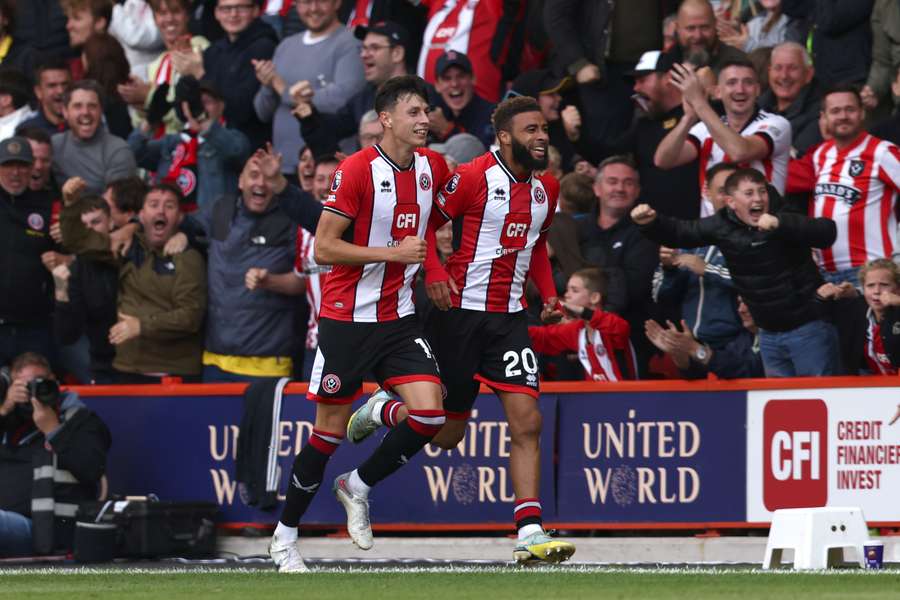 Sheffield United's English defender Jayden Bogle (R) celebrates scoring the equalising goal