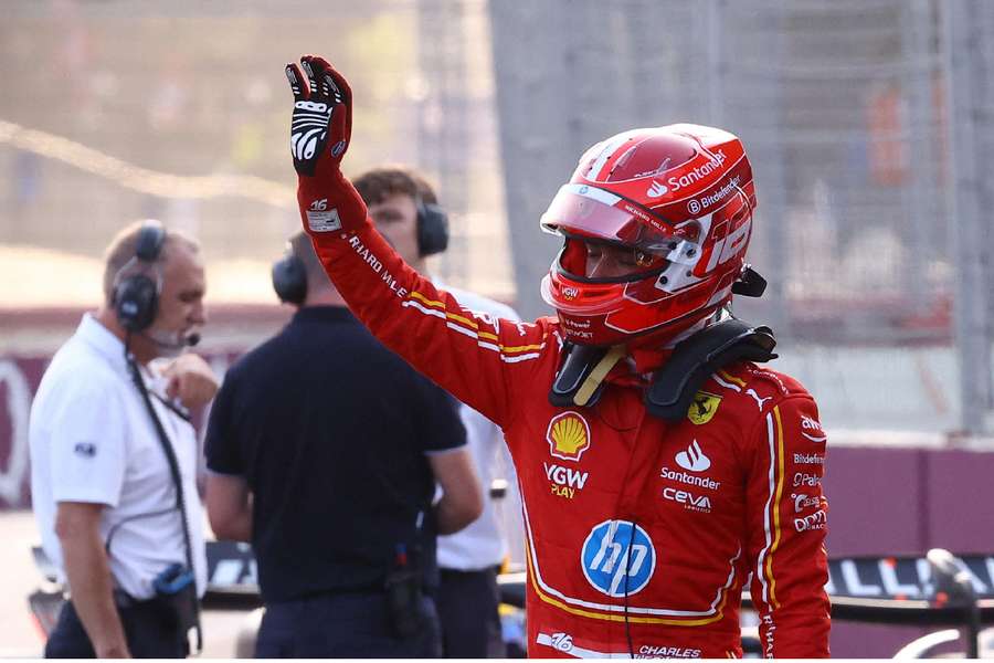 Ferrari's Charles Leclerc celebrates after qualifying in pole position 