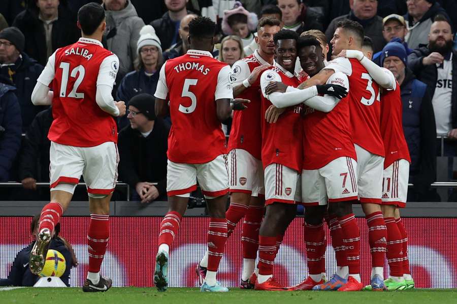 Arsenal's players celebrate after Hugo Lloris' own goal gave them the lead