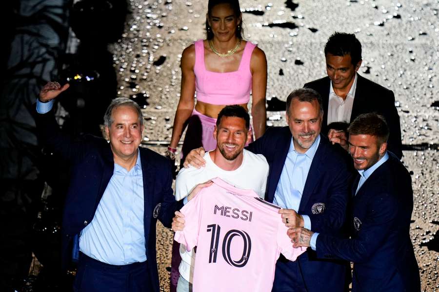 Lionel Messi poses with his new shirt during the presentation