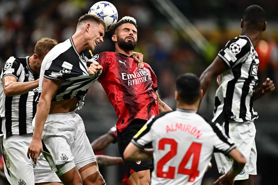 AC Milan's Olivier Giroud battles for the ball