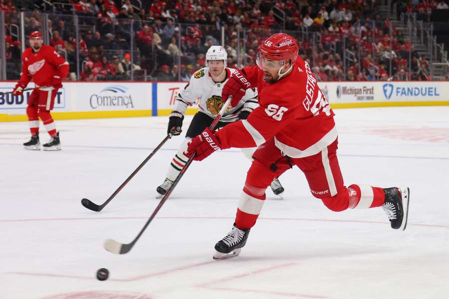 Erik Gustafsson (right) of the Detroit Red Wings takes a shot