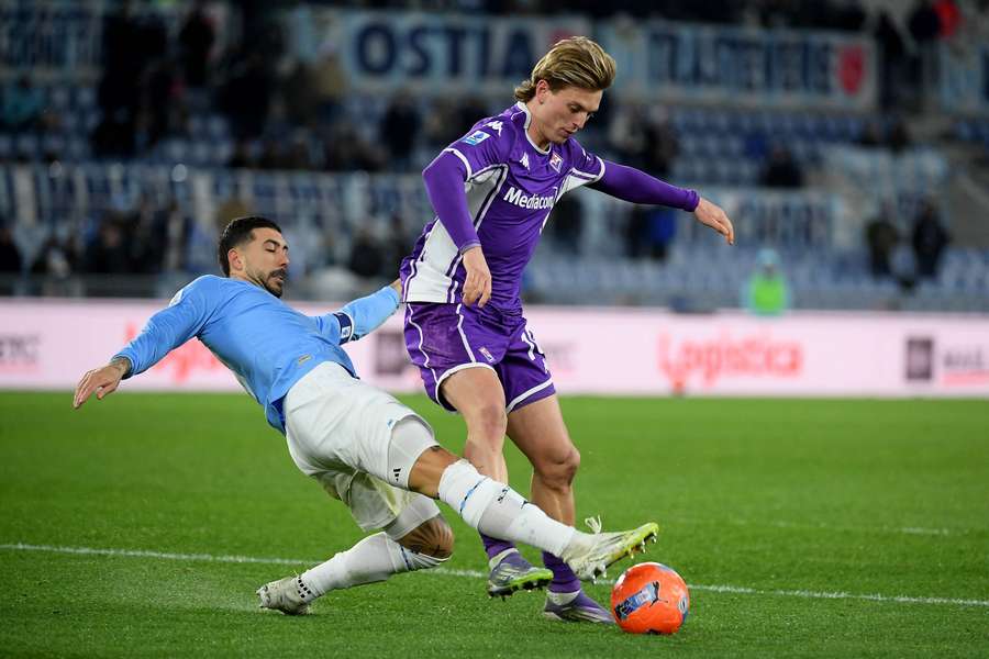 Lazio's Mattia Zaccagni competes for the ball with Albert Gudmundsson