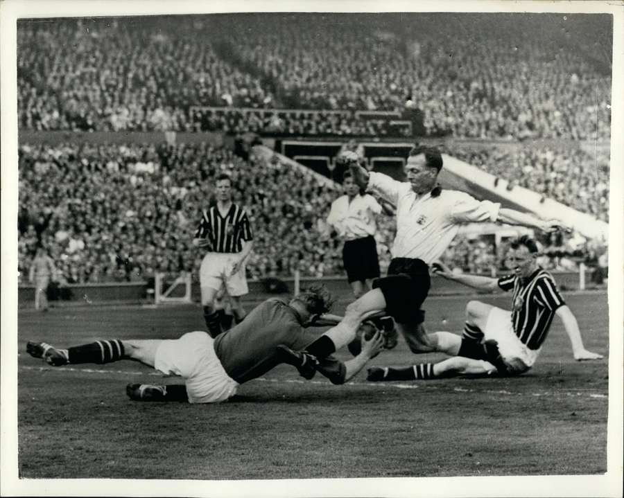 Bert Trautmann of Manchester City dip at the foot of Peter Murphy's Birmingham City during the 1956 FA Cup finals in Wembley Bert Trautmann of Manchester City dip at the foot of Peter Murphy's Birmingham City during the 1956 FA Cup finals in Wembley