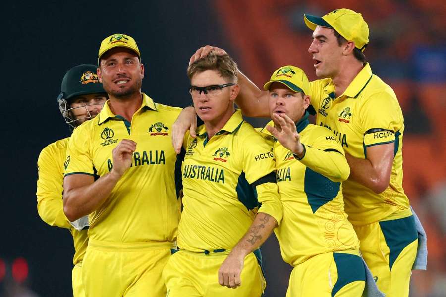 Australia's Adam Zampa celebrates with teammates after taking the wicket of England's Jos Buttler
