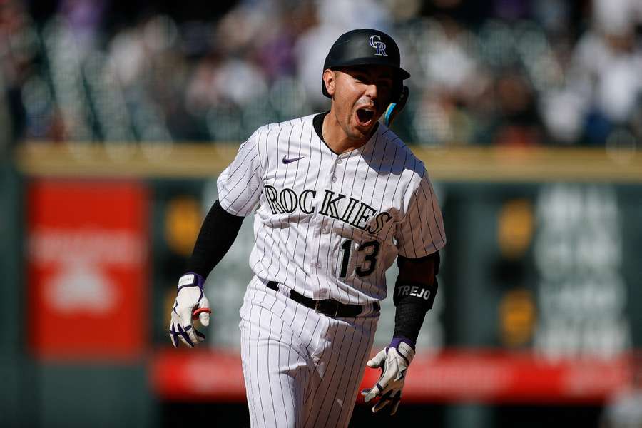 Colorado Rockies second baseman Alan Trejo rounds the bases on a walk-off solo home run in the eleventh inning against the New York Yankees