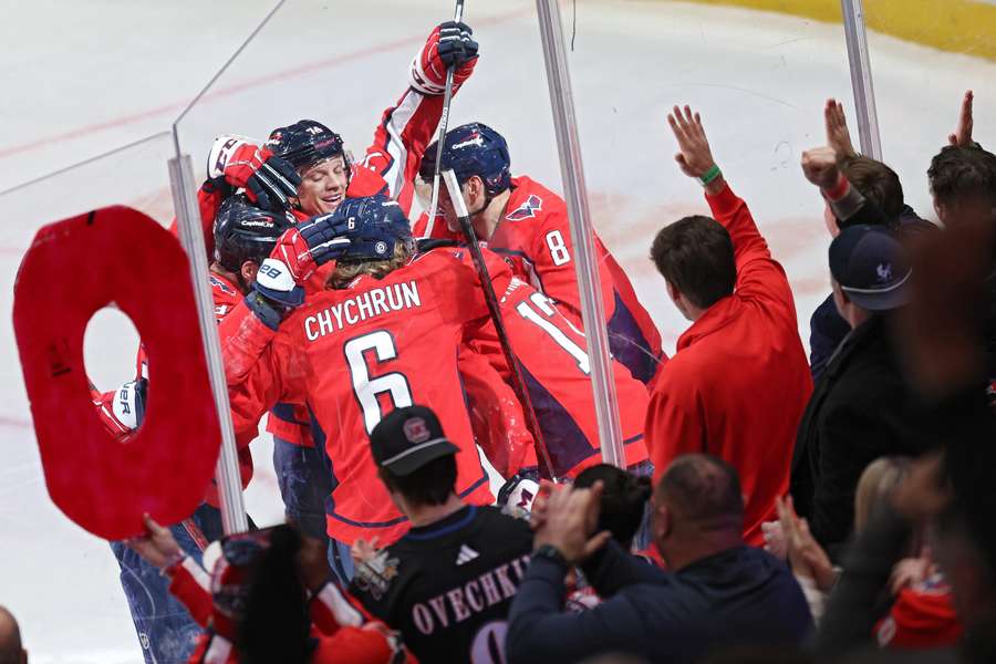 Dylan Strome of the Washington Capitals celebrates with teammates after scoring a goal against the New York Rangers