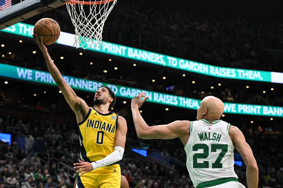 Tyrese Haliburton of the Indiana Pacers lays up a shot against Jordan Walsh of the Boston Celtics
