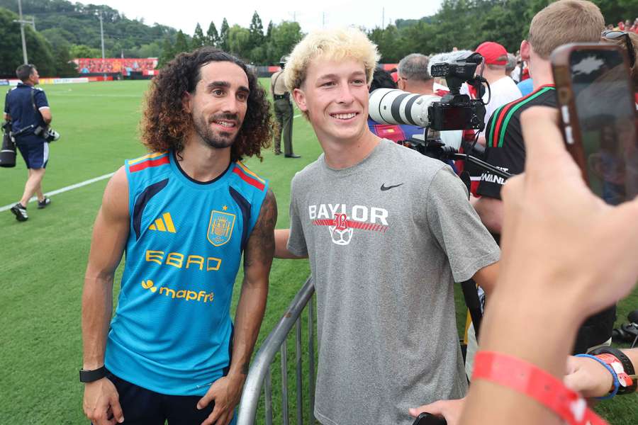 Spain's Marc Cucurella poses for photos with fans after a World Cup training session Spain's Marc Cucurella poses for photos with fans after a World Cup training session