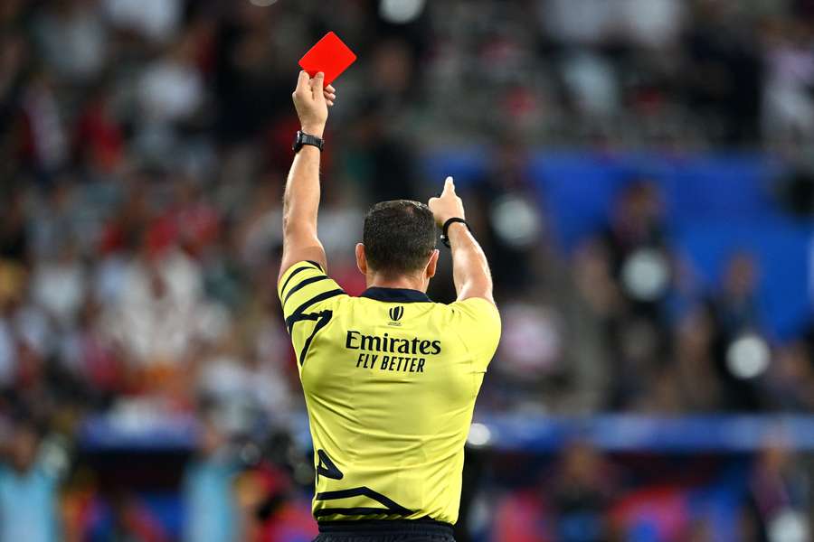 Referee Karl Dickson presents a red card during the Rugby World Cup France 2023