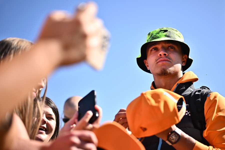 Lando Norris signs hats ahead of the Silverstone Grand Prix