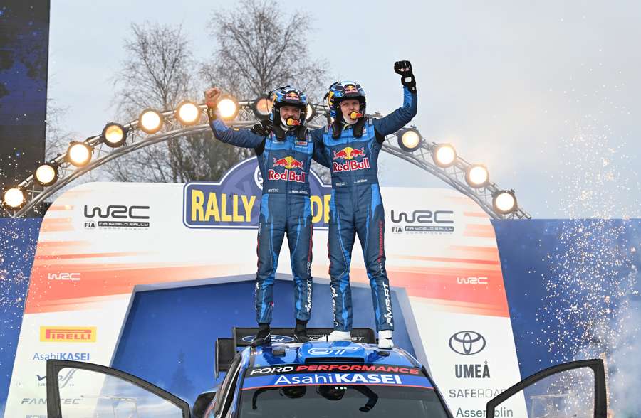 First-placed Ott Tanak (R) and his co-driver Martin Jarveoja celebrate 