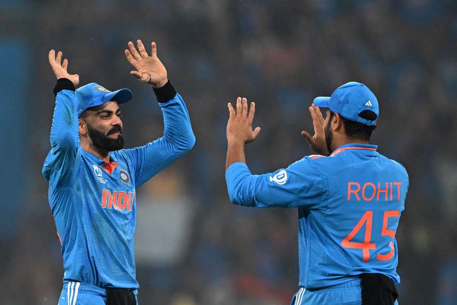 India's Virat Kohli (L) and captain Rohit Sharma celebrate their victory