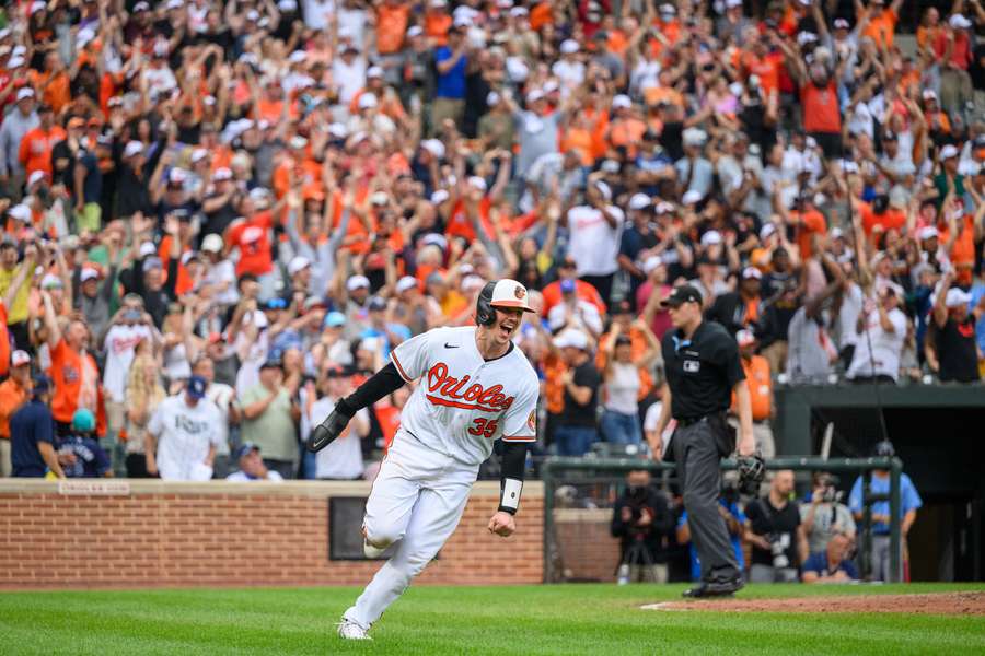 Rutschman scores a run during the eleventh inning against the Tampa Bay Rays