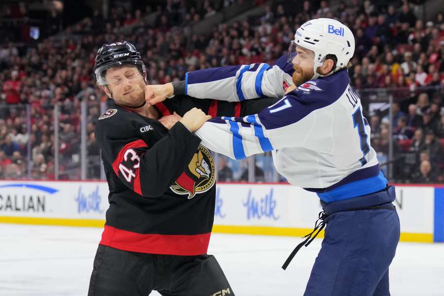 Senators' Tyler Kleven (left) takes a punch from Jets' Adam Lowry (right) during their third-period fight. (February 2025)