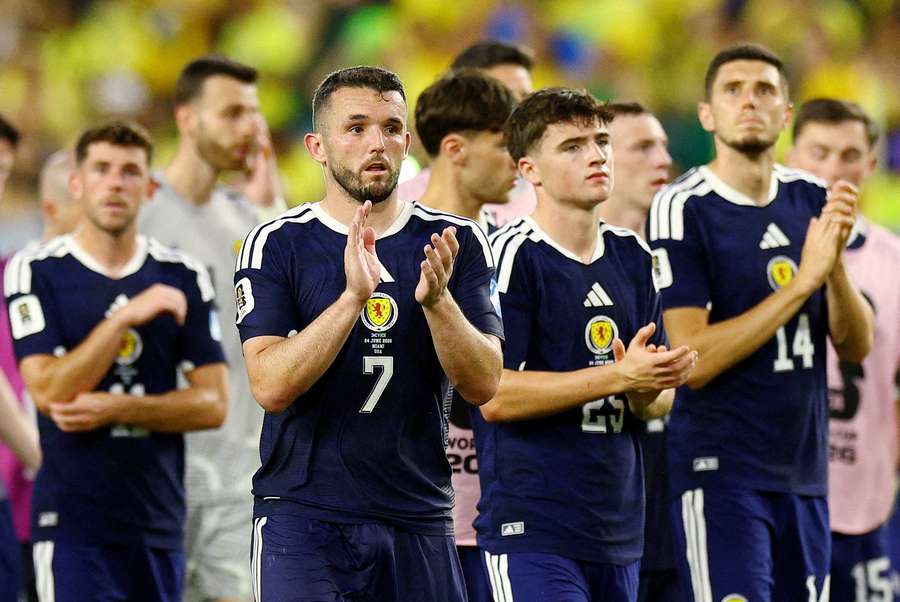 Scotland's John McGinn and teammates look dejected after the defeat to Brazil